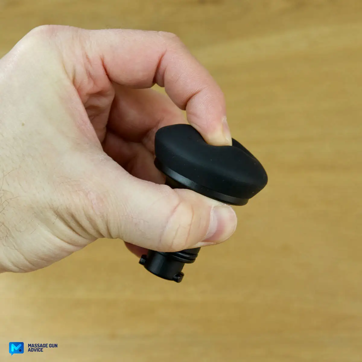 Ekrin Kestrel Review - Is This the Ultimate Massage Gun Unicorn? 23 A hand holding ekrin kestrel massage gun head attachment known as Air Cushion - a finger is pressing the head