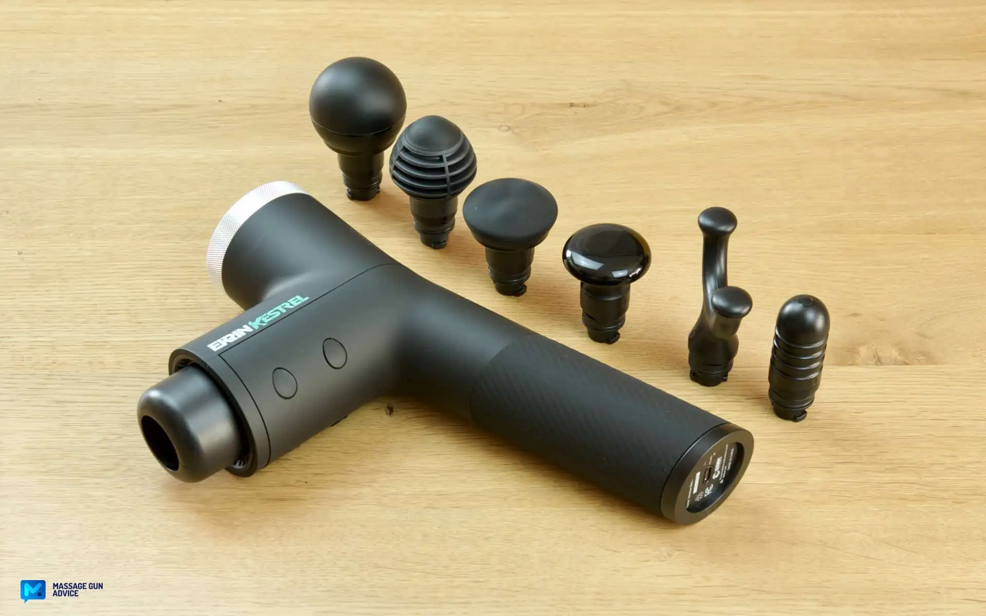Ekrin Kestrel Review - Is This the Ultimate Massage Gun Unicorn? 29 high amplitude massage gun: Ekrin Kestrel laying on a table with All six massage gun Attachments aligned beside it