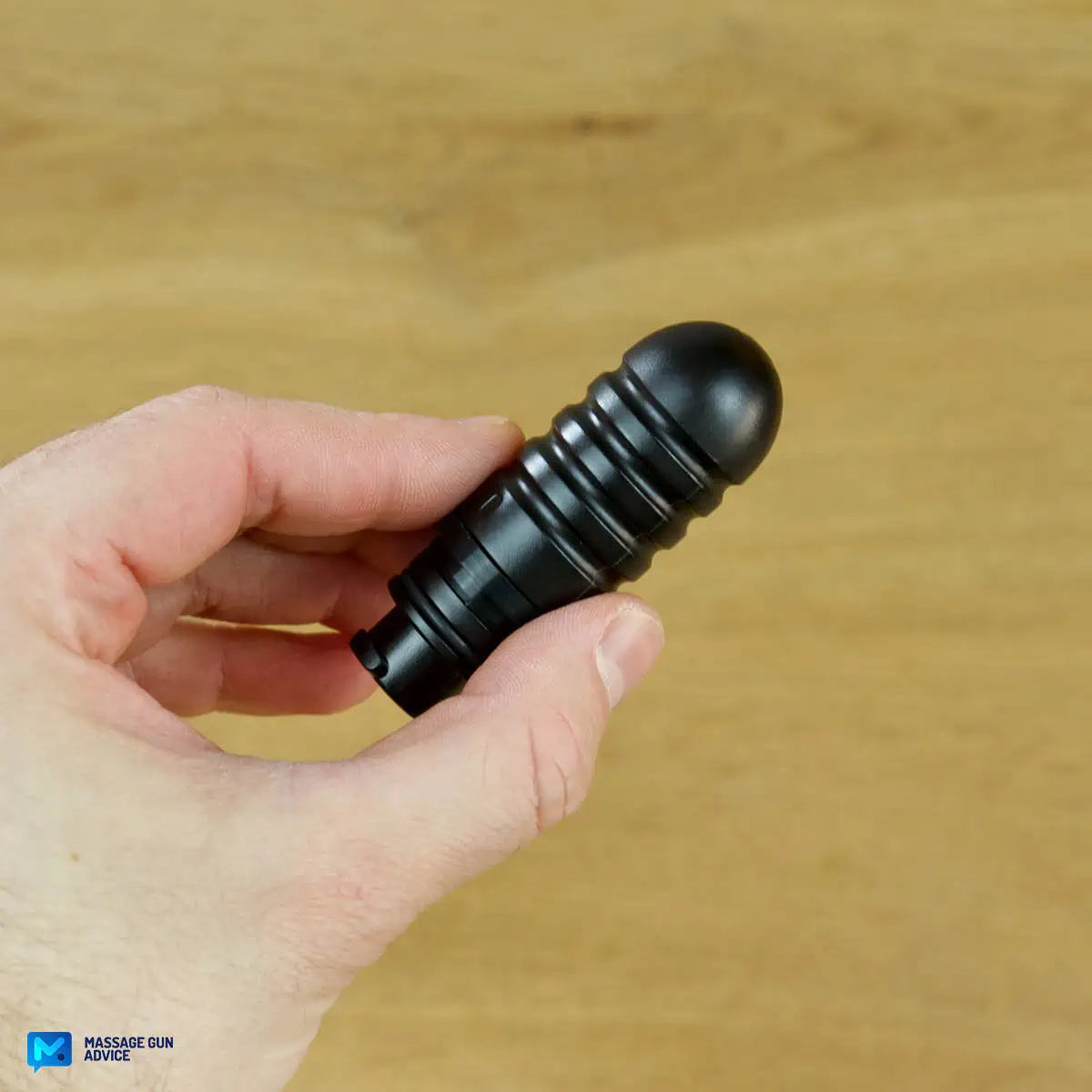 Ekrin Kestrel Review - Is This the Ultimate Massage Gun Unicorn? 28 A hand holding an Ekrin Kestrel massage gun attachment known as Bullet Head