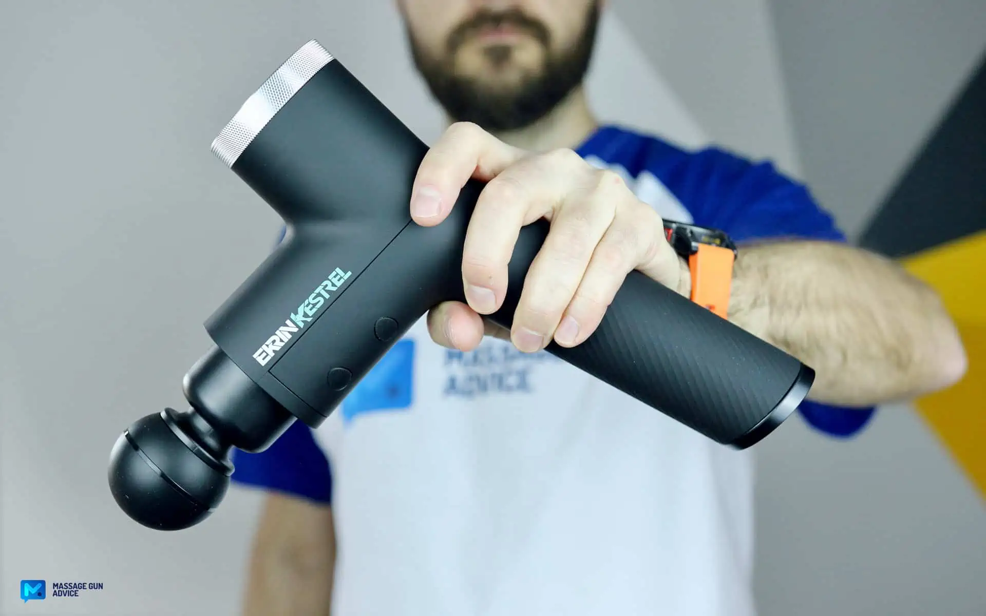 Ekrin Kestrel Review - Is This the Ultimate Massage Gun Unicorn? 1 Ekrin Kestrel review. side photo, hand holding massage gun