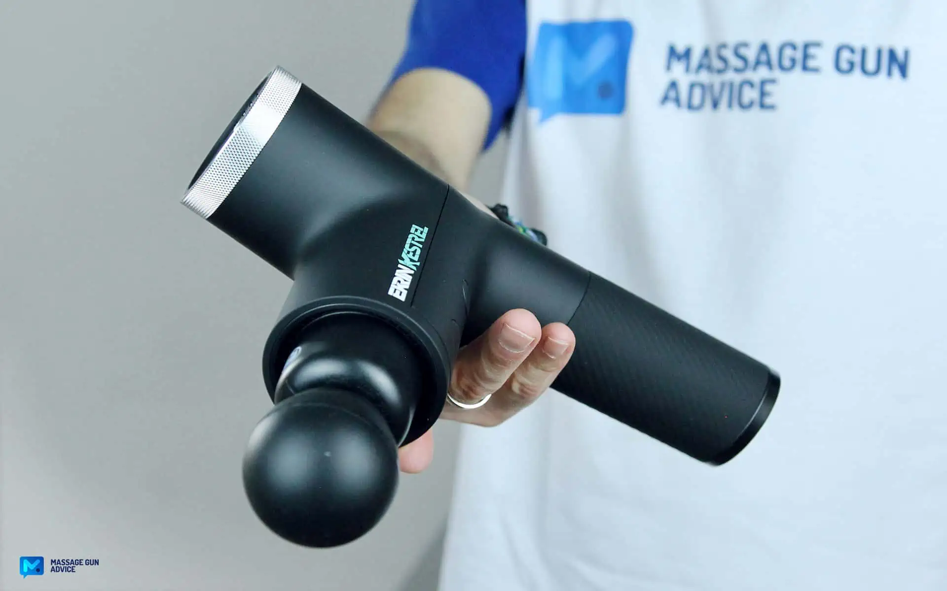 Ekrin Kestrel Review - Is This the Ultimate Massage Gun Unicorn? 37 ekrin Kestrel held by a man on blurred background