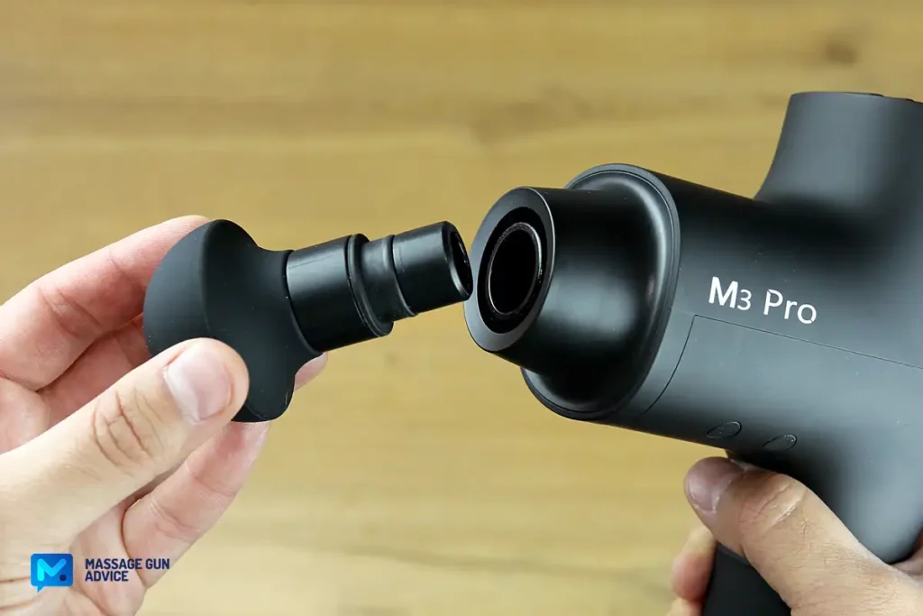 fingers holding massage gun head opposite Opove M3 Pro Head Mounting System Push In