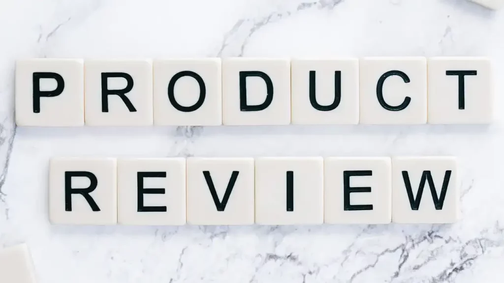 8 Key Factors to Consider Before Buying a Sports Massager 8 product Review spelt with individual square plastic blocks with letters on a granite background