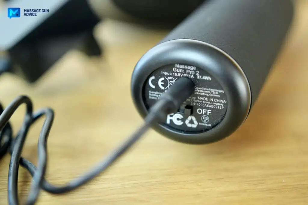 Ultimate Guide to Charging Your Massage Gun: Best Practices and Essential Tips 9 base of a massage gun plugged to a charging cable